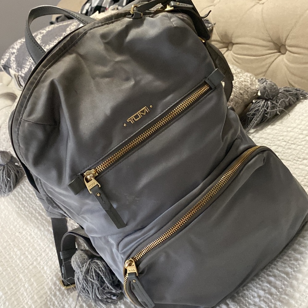 Tumi book bag with strap in the back to connect to your luggage.